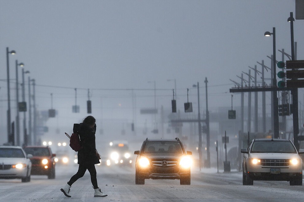 Commuters braves the wind and snow in frigid weather, Wednesday, Jan. 30, 2019, in Cincinnati. The extreme cold and record-breaking temperatures are crawling into a swath of states spanning from North Dakota to Missouri and into Ohio after a powerful snowstorm pounded the region earlier this week. (AP Photo/John Minchillo)