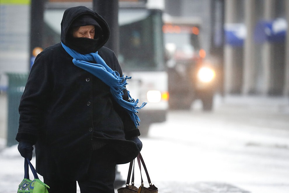 Commuters braves the wind and snow in frigid weather, Wednesday, Jan. 30, 2019, in Cincinnati. The extreme cold and record-breaking temperatures are crawling into a swath of states spanning from North Dakota to Missouri and into Ohio after a powerful snowstorm pounded the region earlier this week. (AP Photo/John Minchillo)