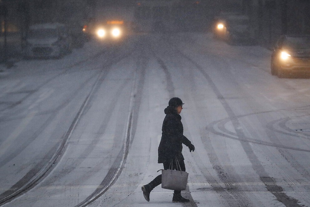 A commuter braves the wind and snow in frigid weather, Wednesday, Jan. 30, 2019, in Cincinnati. The extreme cold and record-breaking temperatures are crawling into a swath of states spanning from North Dakota to Missouri and into Ohio after a powerful snowstorm pounded the region earlier this week. (AP Photo/John Minchillo)