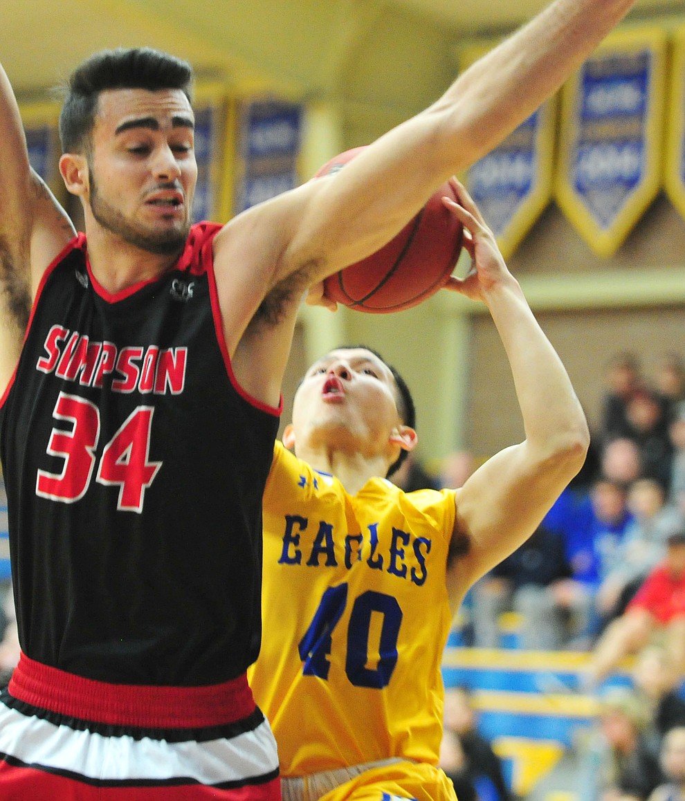Embry Riddle's Conner Verdugo gets acrobatic in making a two-pointer as the Eagles take on the Simpson University Redhawks Thursday, Jan. 31, 2019 in Prescott. (Les Stukenberg/Courier).