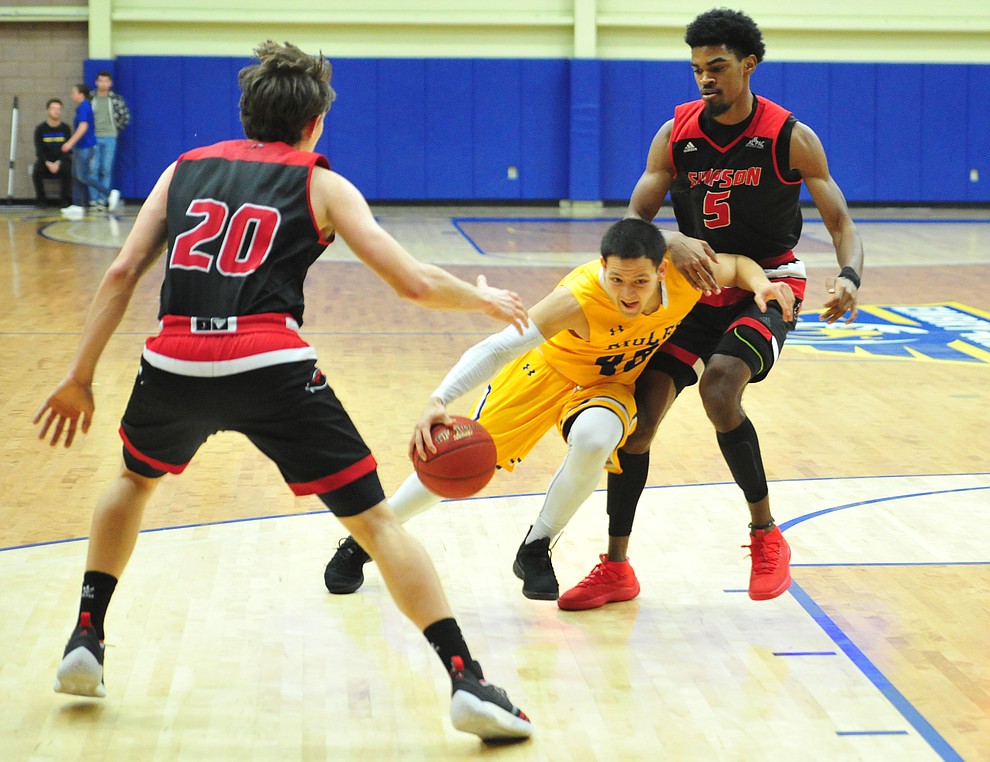 Embry Riddle's Conner Verdugo cuts between a pair of defenders as the Eagles take on the Simpson University Redhawks Thursday, Jan. 31, 2019 in Prescott. (Les Stukenberg/Courier).