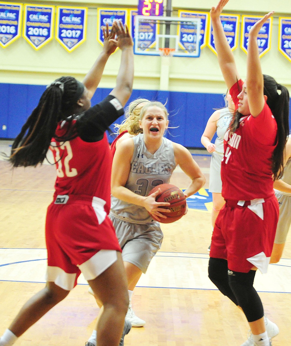 Embry Riddle's Jenna Knudson drives between defenders as the Eagles take on the Simpson University Redhawks Thursday, Jan. 31, 2019 in Prescott. (Les Stukenberg/Courier).