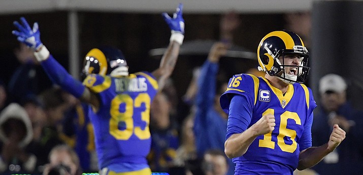 FILE - In this Jan. 12, 2019, file photo, Los Angeles Rams quarterback Jared Goff celebrates after a touchdown by running back C.J. Anderson during the second half in an NFL divisional football playoff game against the Dallas Cowboys in Los Angeles. The wide-eyed, talented Goff will try to lead his Rams past the grizzled, 41-year-old Tom Brady, who is looking to guide the Patriots to their sixth Super Bowl victory.  (Mark J. Terrill/AP, file)