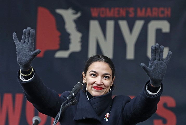 In this Jan. 19, 2019, file photo, U.S. Rep. Alexandria Ocasio-Cortez, (D-New York) waves to the crowd after speaking at Women's Unity Rally in Lower Manhattan in New York. Democrats including Ocasio-Cortez of New York and veteran Sen. Ed Markey of Mass. are calling for a Green New Deal intended to transform the U.S. economy to combat climate change and create jobs in renewable energy. (Kathy Willens/AP, file)