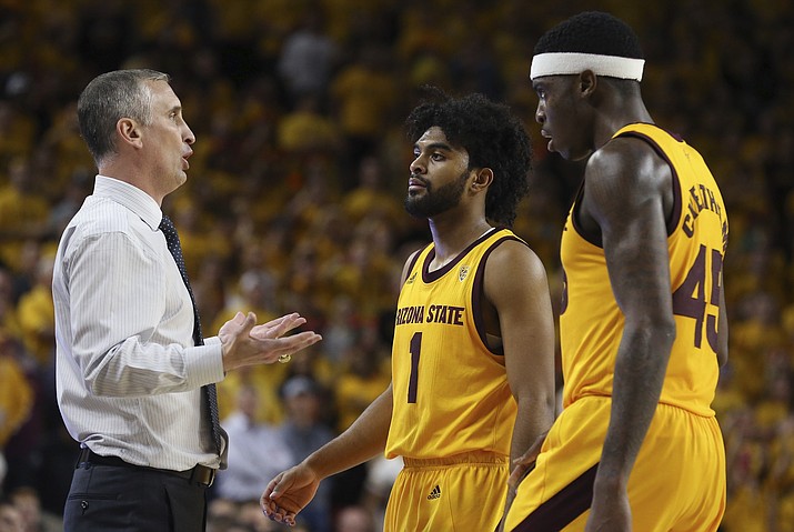 Arizona State head coach Bobby Hurley, left, talks with Arizona State guard Remy Martin (1) and forward Zylan Cheatham (45) during the second half of an NCAA college basketball game against Arizona Thursday, Jan. 31, 2019, in Tempe, Ariz. Arizona State defeated Arizona 95-88 in overtime. (Ross D. Franklin/AP)