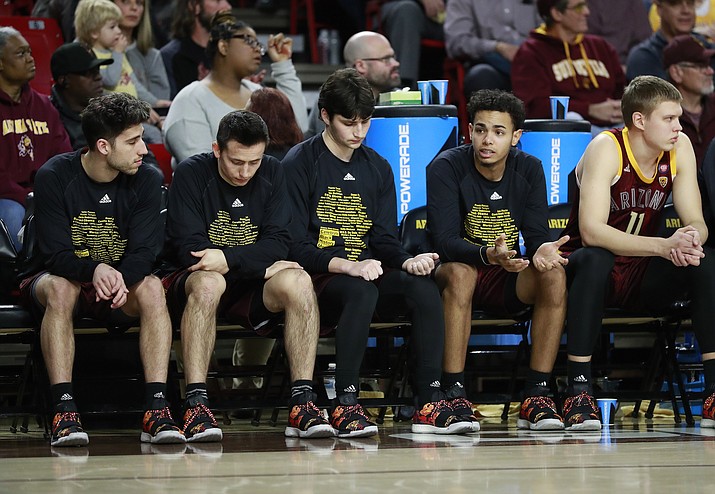 Arizona State players watch from the bench during the first half of an NCAA college basketball game against Washington State, Thursday, Feb. 7, 2019, in Tempe, Ariz. The players at the end of the bench watch the score running up and the clock winding down, wondering when it will be their turn to finally get a chance to play. Most of the time, it doesn't happen until the final minute--even when a game has long been out of reach. (Matt York/AP)