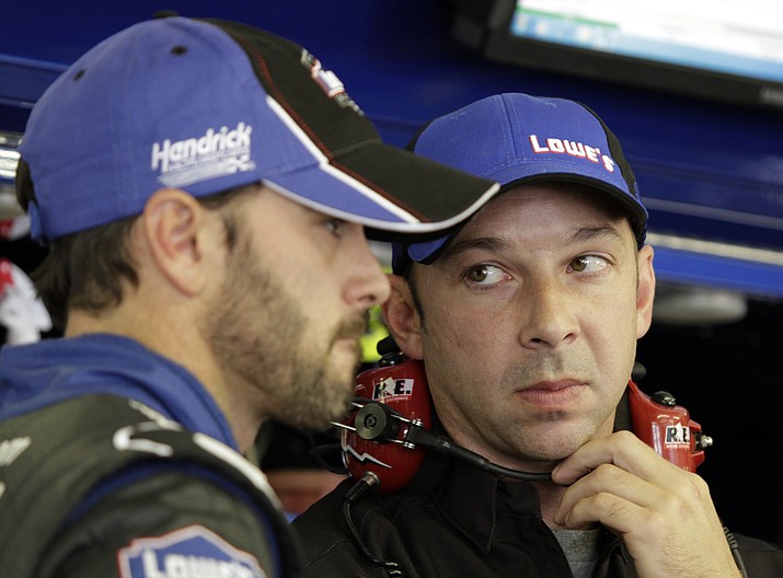 FILE - In this July 15, 2011, file photo, driver Jimmie Johnson, left, talks with crew chief Chad Knaus during practice for the NASCAR Lenox Industrial Tools 300 auto race at New Hampshire Motor Speedway in Loudon, N.H. Knaus is only five years older than Johnson and the two grew up in the Cup Series together.(Mary Schwalm/AP, file)