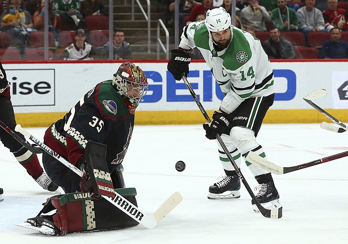 Arizona goaltender Darcy Kuemper makes a save as Dallas Stars left wing Jamie Benn looks for a possible rebound during the first period Saturday, Feb. 9, 2019, in Glendale. (Ross D. Franklin/AP))