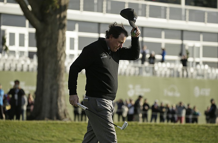 Phil Mickelson tips his hat on the 18th green of the Pebble Beach Golf Links after winning the AT&T Pebble Beach Pro-Am golf tournament Monday, Feb. 11, 2019, in Pebble Beach, Calif. (Eric Risberg/AP)