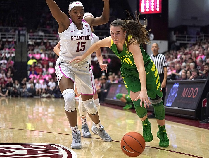 Oregon guard Sabrina Ionescu (20) moves the ball past Stanford forward Maya Dodson (15) during the second half of an NCAA college basketball game Sunday, Feb. 10, 2019, in Stanford, Calif. Oregon won 88-48. (Tony Avelar/AP)