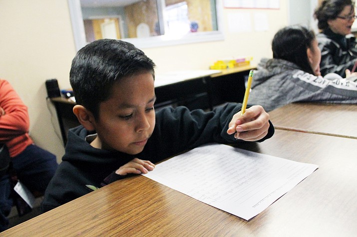 Corde Chiquito, a fourth grade student works on his Navajo language homework at the Pathways after school program Feb. 7 in Flagstaff. (Joshua Butler/NHO)