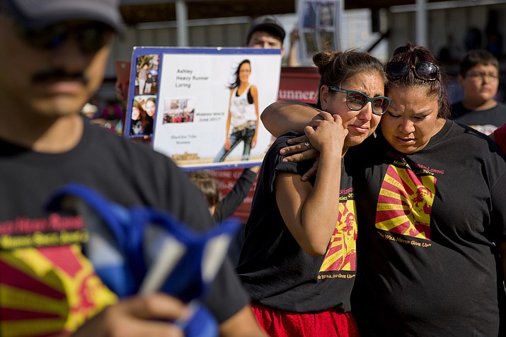 In July 2018 Jenna Loring, left, the aunt of Ashley HeavyRunner Loring, cries with her cousin, Lissa Loring on the Blackfeet Indian Reservation in Browning, Montana. A study released by a Native American non-profit says numerous police departments in cities nationwide are not adequately identifying or reporting cases of missing and murdered indigenous women. (AP Photo/David Goldman, File)