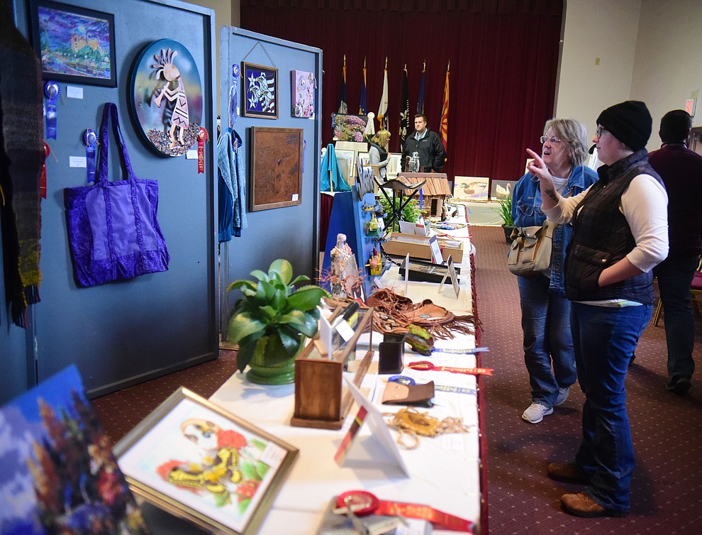 Carolynn and Kayla Wood look at some of the artwork on display at the Prescott VA Veteran's Creative Arts Festival Wednesday, Feb. 13, 2019. 128 pieces are on display at the 25th annual show being held in Building 15, theatre. (Les Stukenberg/Courier).