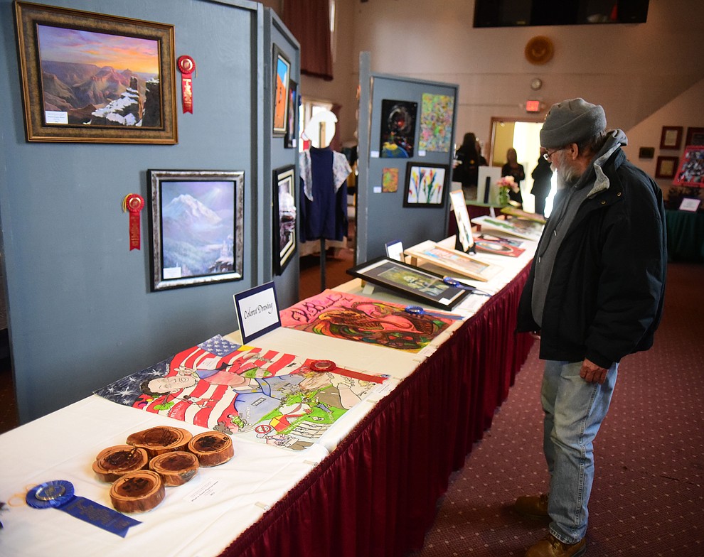 USAF vietnam veteran Roger Anderson looks at some of the artwork on display at the Prescott VA Veteran's Creative Arts Festival Wednesday, Feb. 13, 2019. 128 pieces are on display at the 25th annual show being held in Building 15, theatre. (Les Stukenberg/Courier).