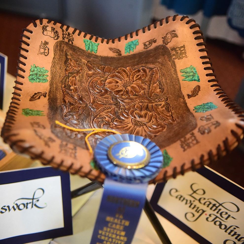Linda Stilson created this Sportsmen's Leather Footstool at the Prescott VA Veteran's Creative Arts Festival Wednesday, Feb. 13, 2019. 128 pieces are on display at the 25th annual show being held in Building 15, theatre. (Les Stukenberg/Courier).