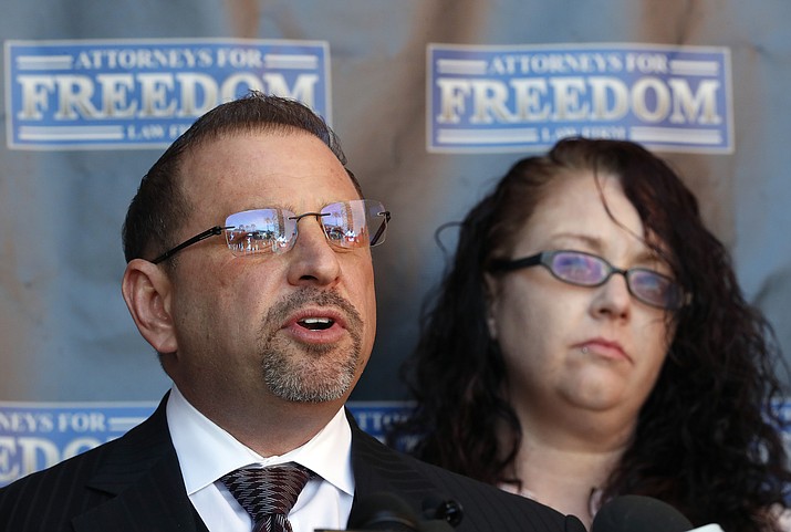 Attorney Marc J. Victor speaks to the media concerning his client, Johnny Wheatcroft, Monday, Feb. 11, 2019, in Chandler, Ariz. as Wheatcroft's wife, Anya Chapman, right, listens. Victor has filed a lawsuit on behalf of Wheatcroft claiming the Glendale, Ariz. police dept. used excessive force against Wheatcroft during his arrest in 2017. (Matt York/AP)