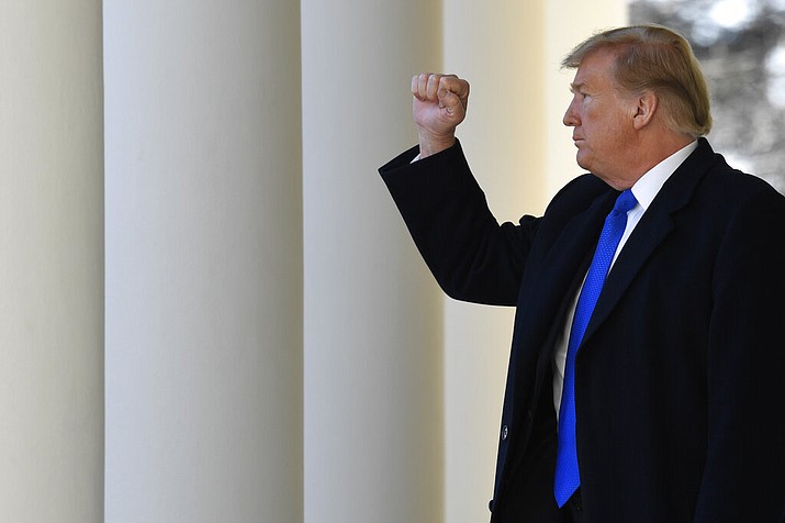 President Donald Trump gestures to the audience as he heads to the Oval Office after speaking during an event in the Rose Garden at the White House in Washington, Friday, Feb. 15, 2019, to declare a national emergency in order to build a wall along the southern border. (AP Photo/Susan Walsh)