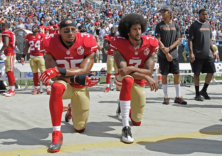 In this Sept. 18, 2016, file photo, San Francisco 49ers’ Colin Kaepernick (7) and Eric Reid (35) kneel during the national anthem before an NFL football game against the Carolina Panthers, in Charlotte, N.C. Colin Kaepernick and Eric Reid have reached settlements on their collusion lawsuits against the NFL, the league said Friday, Feb. 19, 2019. (Mike McCarn/AP, File)