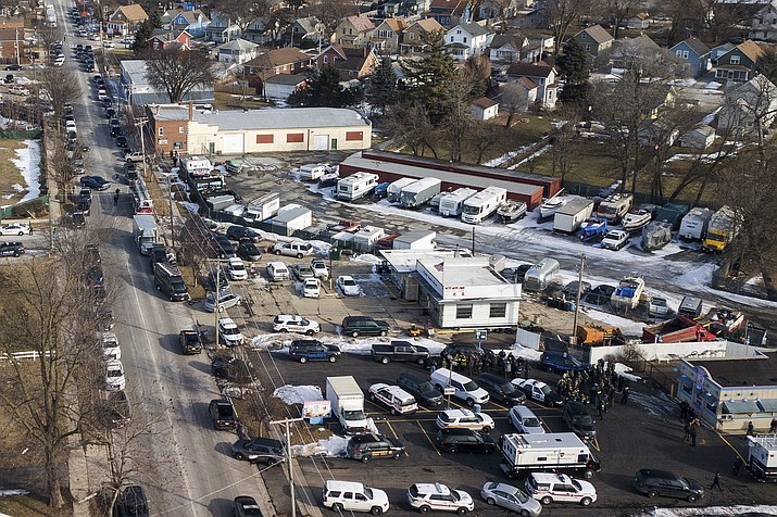 Law enforcement personnel gather near the scene of a shooting at an industrial park in Aurora, Ill., on Friday, Feb. 15, 2019. (Bev Horne/Daily Herald via AP)