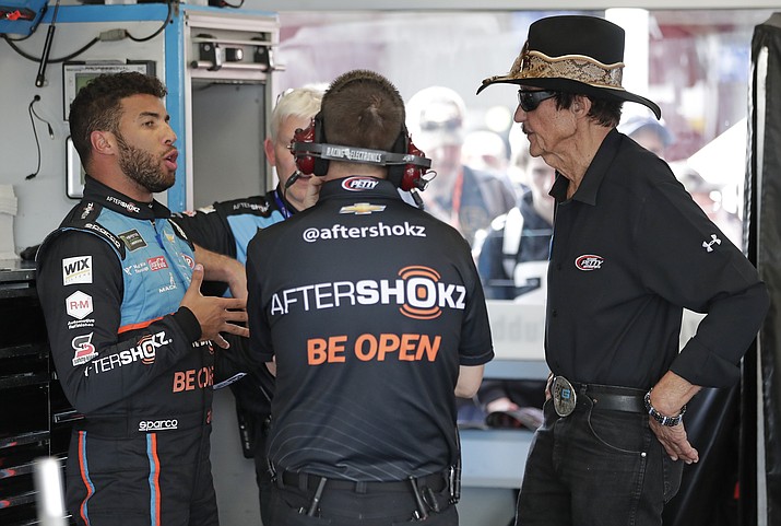 Darrell Wallace Jr., left, talks with car owner Richard Petty, right, and other crew members in his garage during a practice session for the NASCAR Daytona 500 at Daytona International Speedway, Friday, Feb. 15, 2019, in Daytona Beach, Fla. (John Raoux/AP)