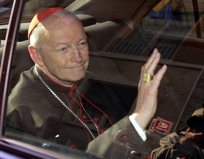 In this April 23, 2002 file photo Cardinal Theodore McCarrick of the Archdiocese of Washington, waves as he arrives at the Vatican in a limousine. On Saturday, Feb. 16, 2019 the Vatican announced Pope Francis defrocked former U.S. Cardinal Theodore McCarrick after Vatican officials found him guilty of soliciting for sex while hearing Confession. (Andrew Medichini/AP, file)