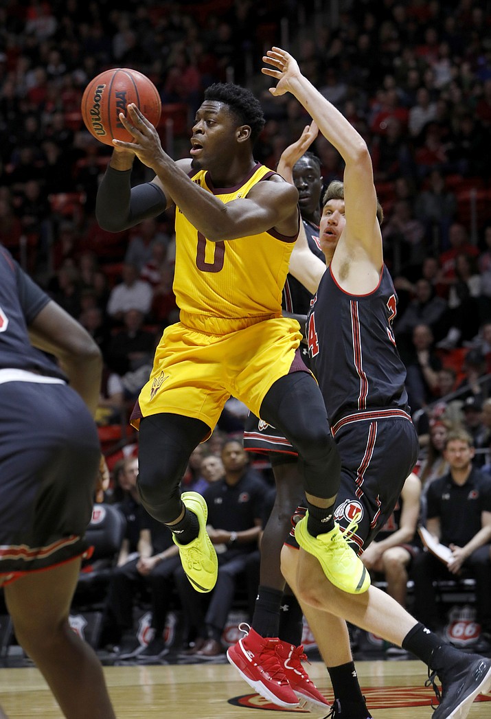 Arizona State’s Luguentz Dort (0) looks to pass the ball as Utah’s Jayce Johnson, right, defends during the first half of an NCAA college basketball game Saturday, Feb. 16, 2019, in Salt Lake City. (Kim Raff/AP)
