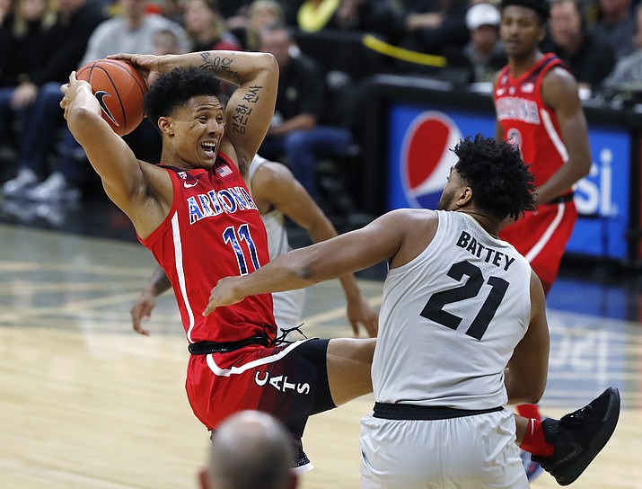 Arizona forward Ira Lee, left, pulls in a rebound as Colorado forward Evan Battey defend in the first half of an NCAA college basketball game Sunday, Feb. 17, 2019, in Boulder, Colo. (David Zalubowski/AP)