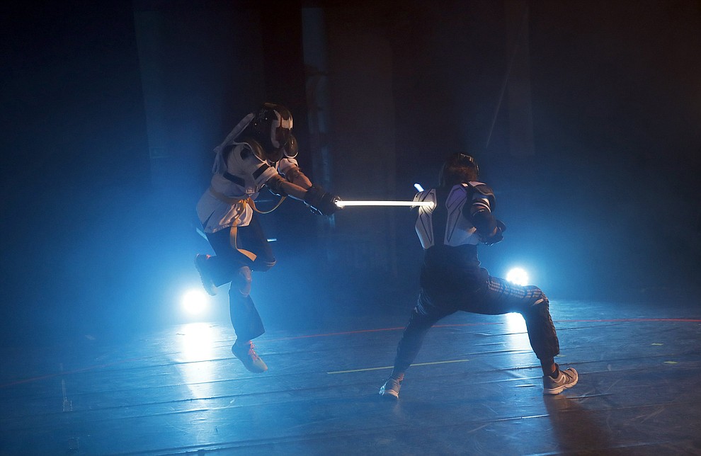 In this Sunday, Feb. 10, 2019, photo, competitors battle during a national lightsaber tournament in Beaumont-sur-Oise, north of Paris. "We wanted it to be safe, we wanted it to be umpired and, most of all, we wanted it to produce something visual that looks like the movies, because that is what people expect," said Michel Ortiz, the tournament organizer. (AP Photo/Christophe Ena)