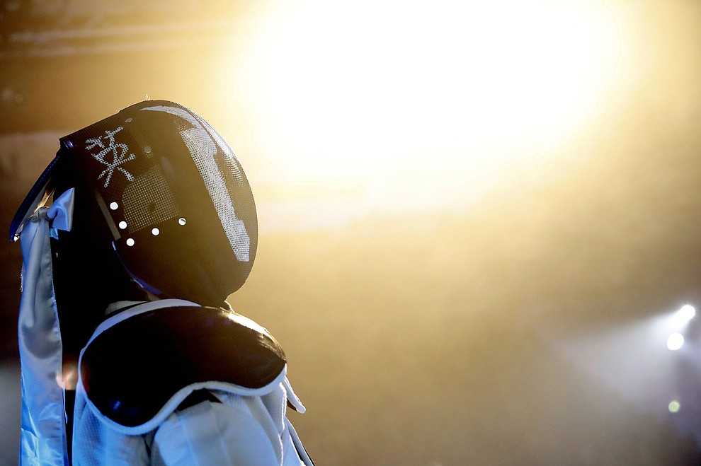 In this Sunday, Feb. 10, 2019, photo, a competitor prepares for his combat during a national lightsaber tournament in Beaumont-sur-Oise, north of Paris. (AP Photo/Christophe Ena)