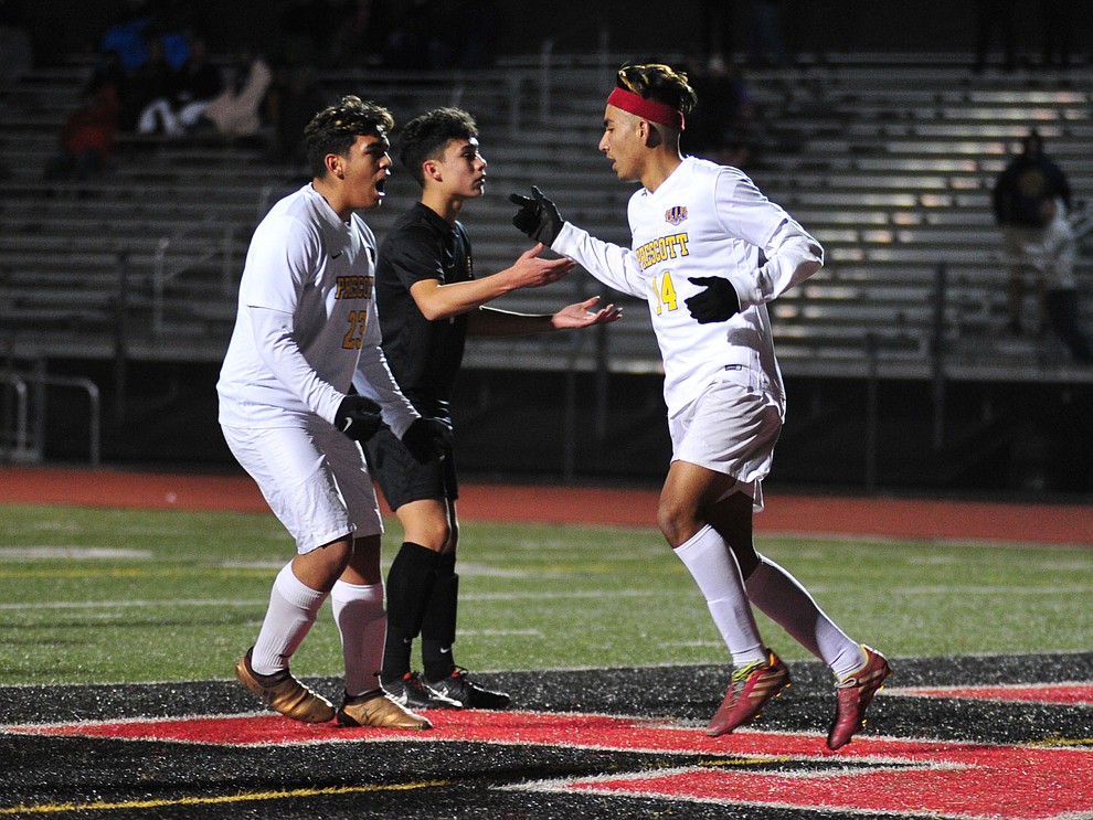 Prescott's Bryant Chavira, left, congratulates Fernando Rodriguez on his first half goal as the Badgers take on the Salpointe Catholic Lancers in the Arizona Interscholastic Association 4A State Soccer Championship Tuesday, February 19, 2019 at Williams Field High School in Gilbert. (Les Stukenberg/Courier).