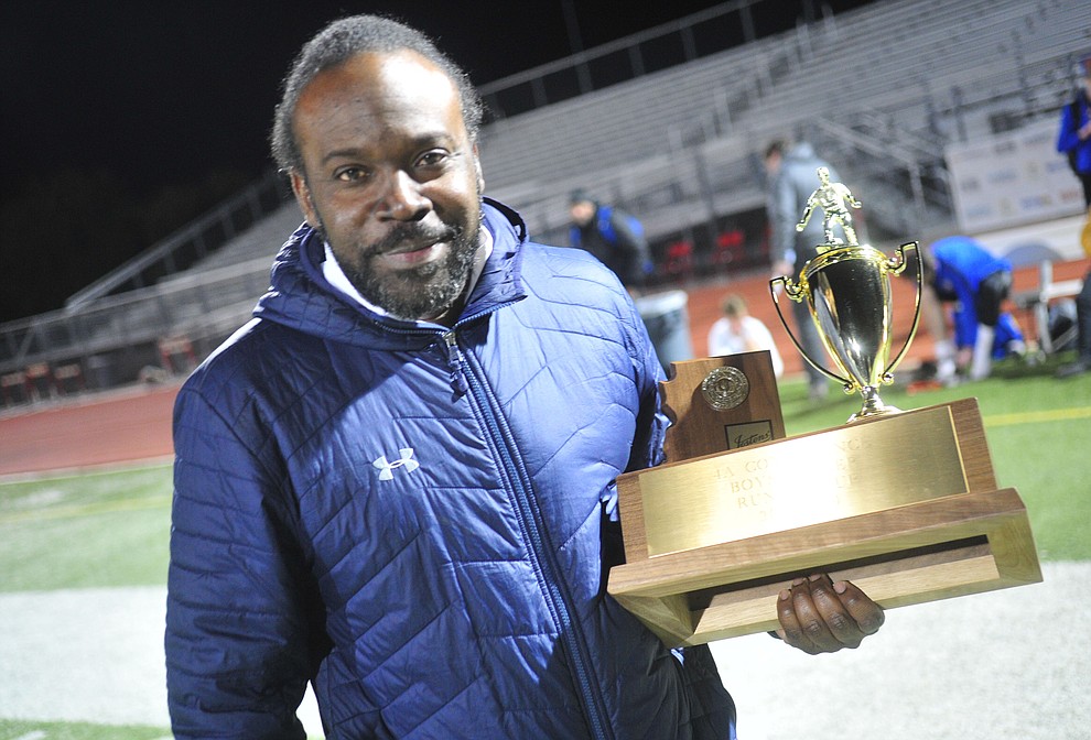 Prescott Head Coach Phil Reid holds the runnerup trophy after the Badgers lost to the Salpointe Catholic Lancers in the Arizona Interscholastic Association 4A State Soccer Championship Tuesday, February 19, 2019 at Williams Field High School in Gilbert. (Les Stukenberg/Courier).