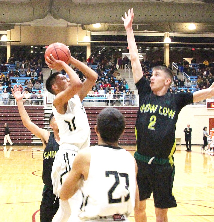 Chinle’s Cooper Burbank drives the baseline and attempts a shot over the out stretched defense of Show Low’s Cotton McGinnis during the 2019 AIA Boys Basketball 3A State championships second round game, hosted by the Ganado Hornets Pavilion. (Anton Wero/NHO)