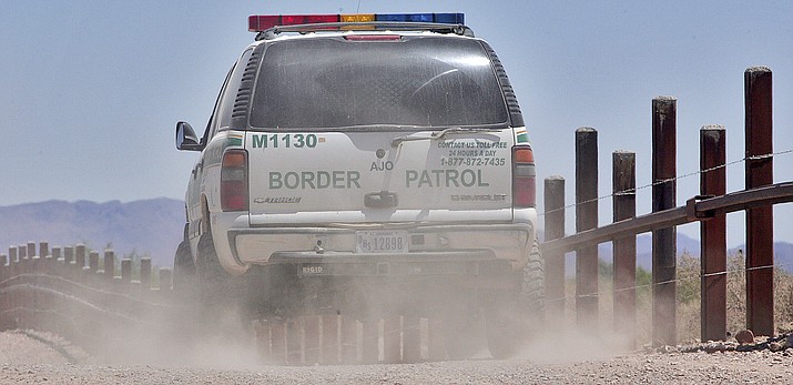 A U.S. Border Patrol agent patrols the international border separating Sonoyta, Mexico, right of fence, and Lukeville on May 26, 2006, in Organ Pipe Cactus National Monument. (Matt York/AP, file)