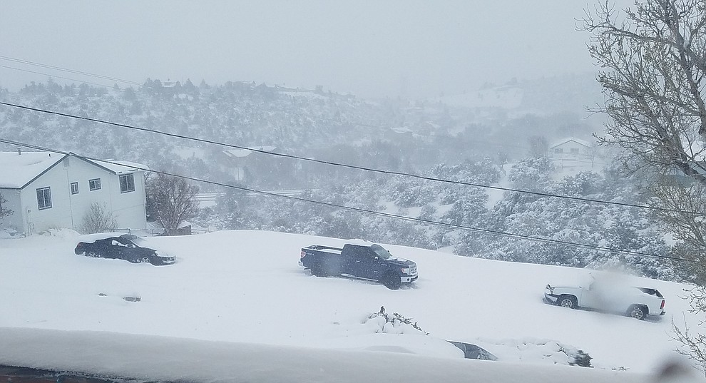 NOPE! Not making it up or down this road in Diamond Valley, AZ! Trucks and car staying put while drivers walk home. (Donna Dotzler)