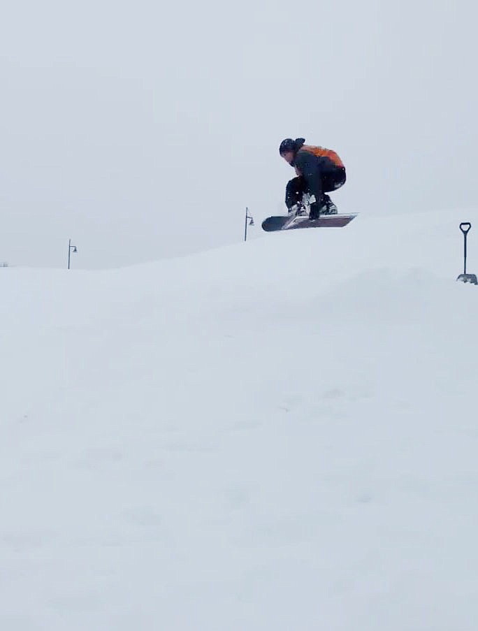 Morgan Palmer-Lacey getting a little airtime while grabbing his snowboard!