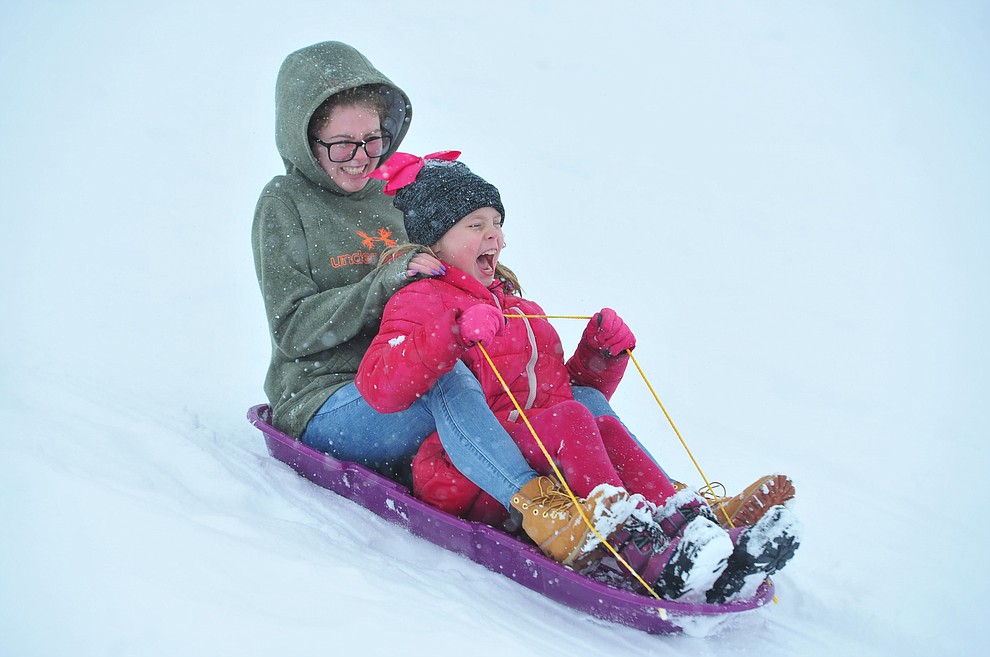 Mattison and Riley enjoy a sled trip down the hill at Mountain Valley Park in Prescott Valley Friday, Feb. 22, 2019