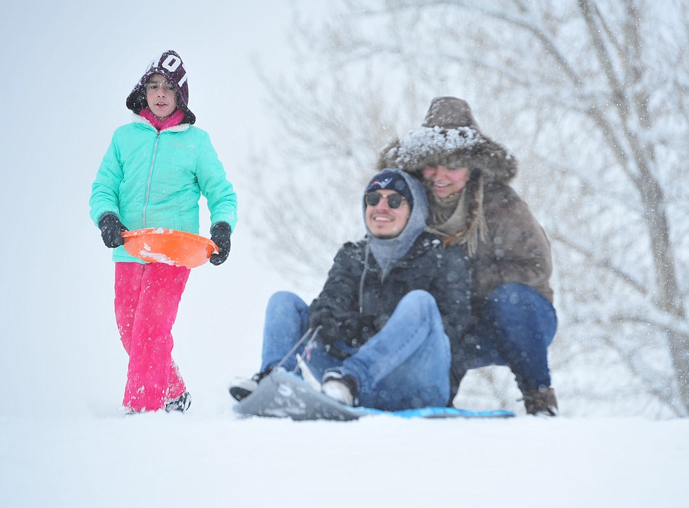 Briseis Rendon, Chris Pedraza and Giselle Martinez enjoy sledding at Mountain Valley Park in Prescott Valley Friday, Feb. 22, 2019. (Les Stukenberg/Courier)