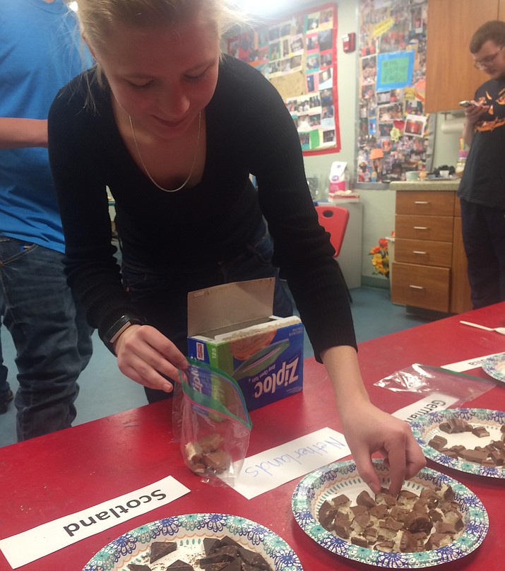 Jennifer Knight takes some chocolate from around the world at the Chocolate Fever Festival for Teens at the Prescott Public Library Saturday, Feb. 23. (Jason Wheeler/Courier)