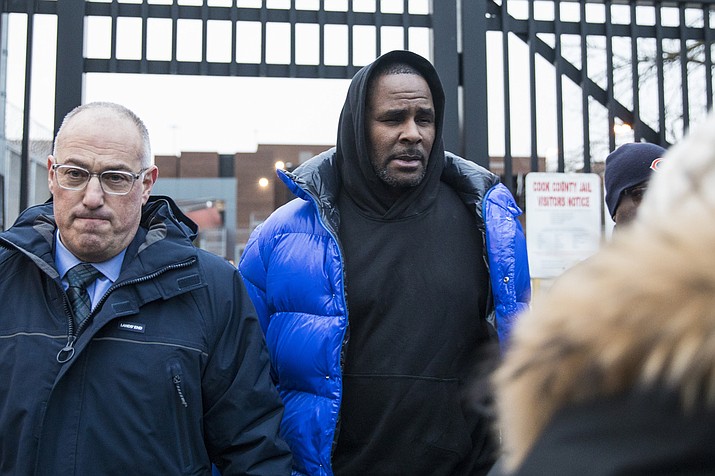 R. Kelly walks out of Cook County Jail with his defense attorney, Steve Greenberg, after posting $100,000 bail, Monday, Feb. 25, 2019 in Chicago. The R&B singer has entered a not guilty plea to all 10 counts of aggravated criminal sexual abuse. (Ashlee Rezin/Chicago Sun-Times via AP)