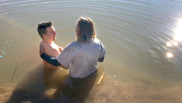 US Navy Corpsman Reece Raykovitz, 26, is baptized by his father-in-law Craig Walker Monday in the Verde River. VVN/Vyto Starinskas