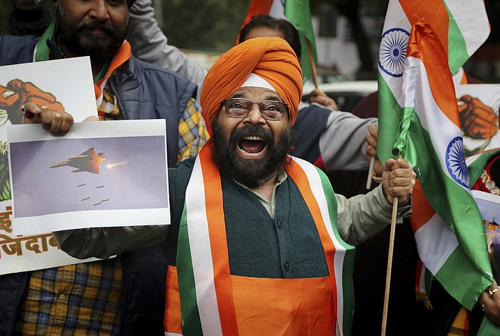 A National Akali Dal leader shouts slogans in support of India and against Pakistan as he celebrates reports of Indian aircrafts bombing Pakistan territory, in New Delhi, India, Tuesday, Feb. 26, 2019.  (AP Photo/Altaf Qadri)
