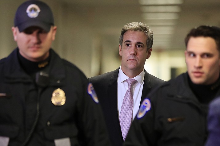 Michael Cohen, President Donald Trump's former lawyer, back center, leaves after a closed door Senate Intelligence Committee hearing on Capitol Hill in Washington, Tuesday, Feb. 26, 2019. (AP Photo/Manuel Balce Ceneta)
