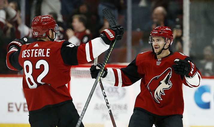 Arizona Coyotes center Vinnie Hinostroza, right, celebrates his goal against Florida with Coyotes defenseman Jordan Oesterle during the shootout Tuesday, Feb. 26, 2019, in Glendale. The Coyotes won 4-3. (Ross D. Franklin/AP)