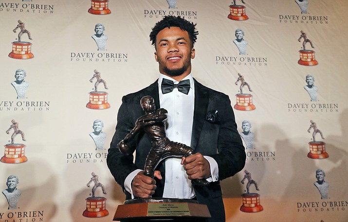 In this Feb. 18, 2019, file photo, Heisman Trophy winning quarterback Kyler Murray poses with the Davey O'Brien football award, in Fort Worth, Texas. Murray's measurements were among the most anticipated at this year's NFL scouting combine after he spurned the Oakland Athletics and a career in Major League Baseball for a shot at the NFL. (LM Otero/AP, file)