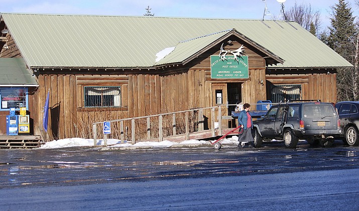 In this Feb. 26, 2019 photo is the Fritz Creek General Store, shown near Homer, Alaska. A cat named Stormy that has spent more than six years as a fixture in a remote Alaska general store is being forced out after officials notified the store owners that the cat's presence violates food safety standards. The Homer News reported Thursday, Feb. 28, 2019, that the Fritz Creek General Store near the small city of Homer has been home for Stormy since 2012. (Megan Pacer/Homer News via AP)