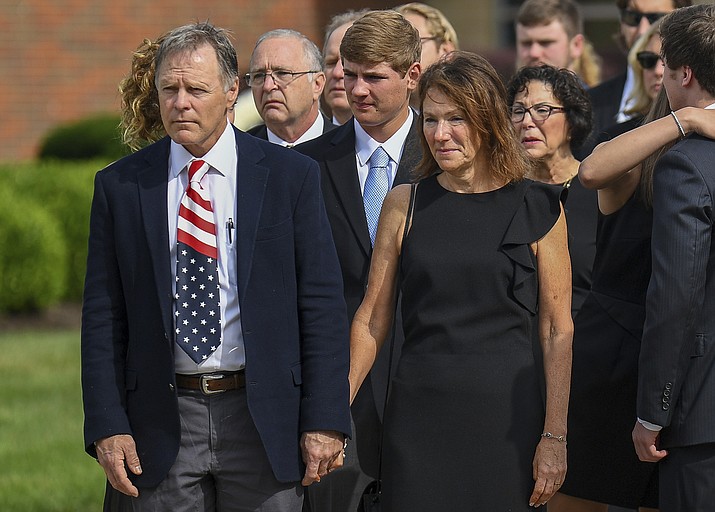 Fred and Cindy Warmbier watch June 22, 2017, as their son Otto's casket is placed in a hearse after his funeral Wyoming, Ohio. (Bryan Woolston/AP, File)