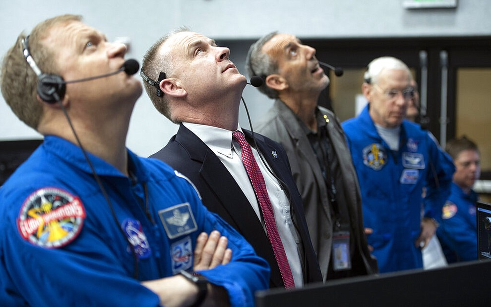 NASA astronaut Eric Boe, assistant to the chief of the astronaut office for commercial crew, left, and Norm Knight, deputy director of flight operations at NASA's Johnson Space Center watch the launch of a SpaceX Falcon 9 rocket carrying the company's Crew Dragon spacecraft on the Demo-1 mission from firing room four of the Launch Control Center, Saturday, March 2, 2019 at the Kennedy Space Center in Florida. America's newest capsule for astronauts rocketed Saturday toward the International Space Station on a high-stakes test flight by SpaceX. (NASA/Joel Kowsky)