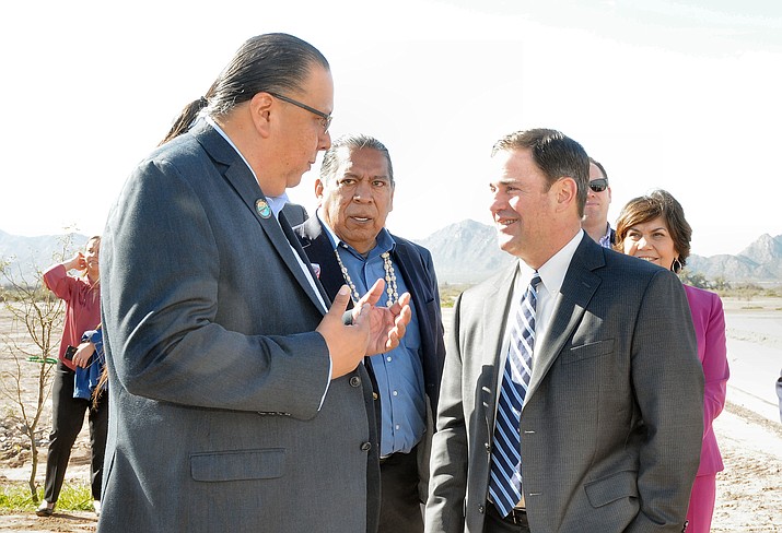 Arizona Gov. Doug Ducey, right, chats with Gila River Gov. Stephen Rae Lewis Friday at the formal inauguration of a recharge product and cultural display on tribal grounds. (Howard Fischer/Capitol Media Services)