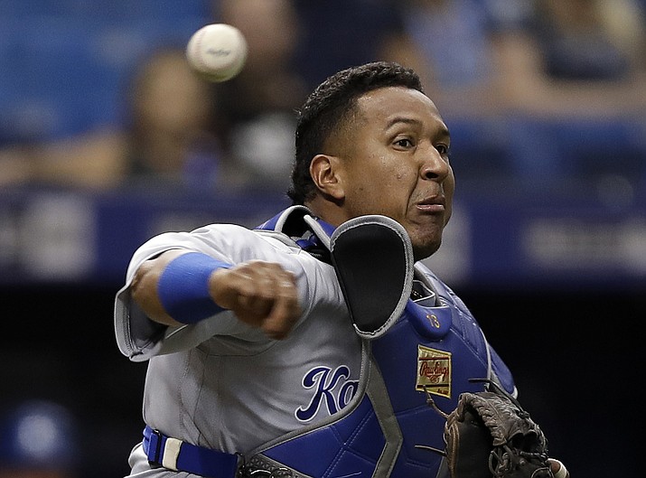 In this Aug. 21, 2018, file photo, Kansas City Royals catcher Salvador Perez throws out Tampa Bay Rays' Kevin Kiermaier at first on a slowly rolling ground ball during the fifth inning of a baseball game in St. Petersburg, Fla. Perez will undergo Tommy John surgery to repair a torn ligament in his right elbow, keeping the six-time All-Star off the field for the entire 2019 season. (Chris O'Meara/AP, file)