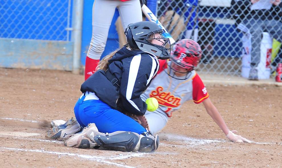 Prescott's Danner Cozens tries to get the out at home as the Badgers host Seton Catholic on a blustery day Friday, March 8, 2019. Les Stukenberg/Courier)